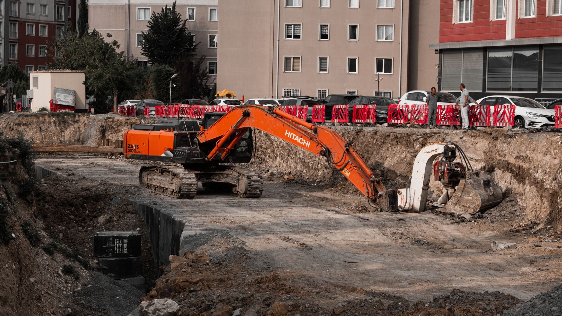 Excavators operating at an urban construction site — heavy equipment that requires specialist diesel maintenance